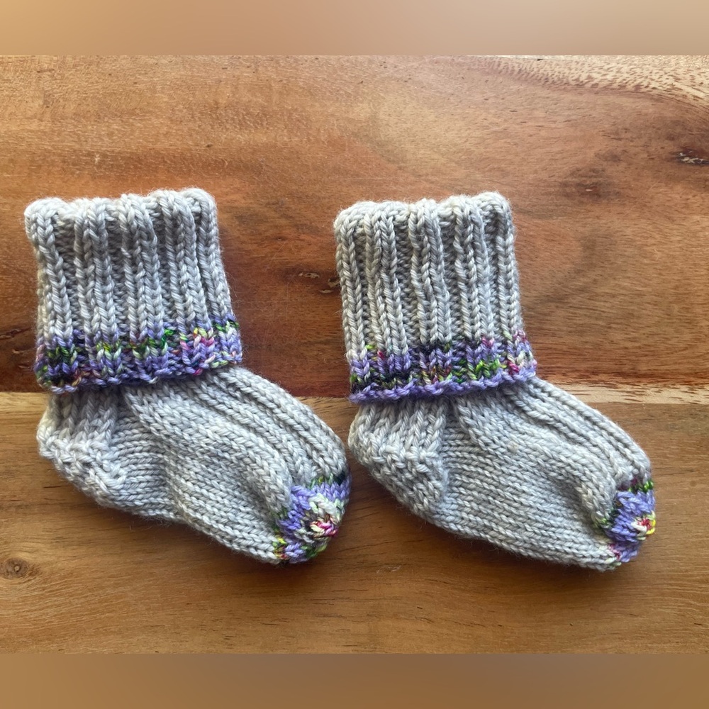 Last chance! 
Hand knit Baby Socks—that will actually stay on your baby’s feet!